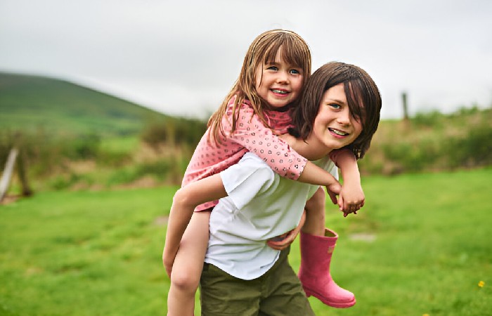 A sister on her brother's shoulders 