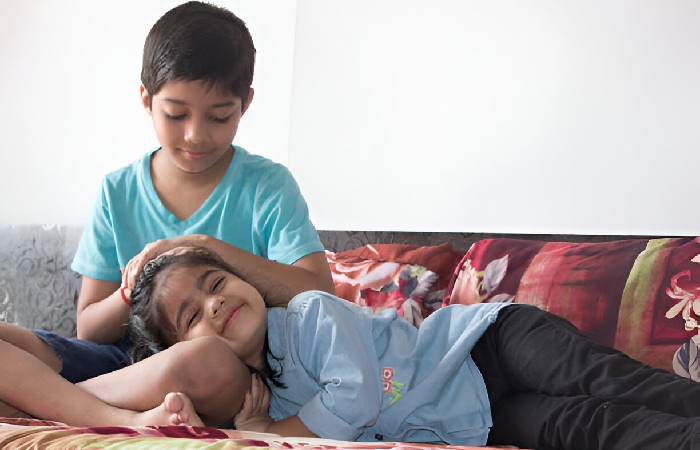 Sister sleeping on Brother's Lap